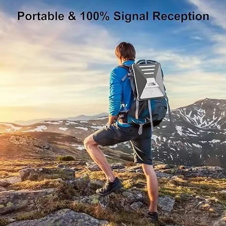 Hiker carrying Starlink Mini in grey silicone protective cover on mountain trail