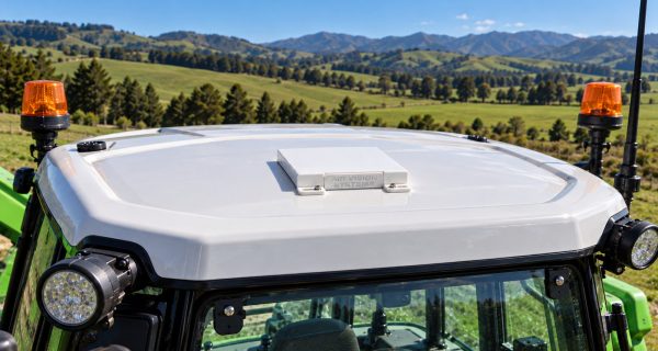 Close-up of a Starlink Mini mount on a tractor cab roof